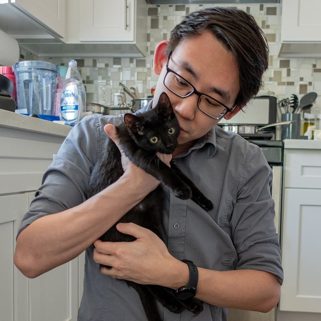 Adam Parkzer holding a black kitten